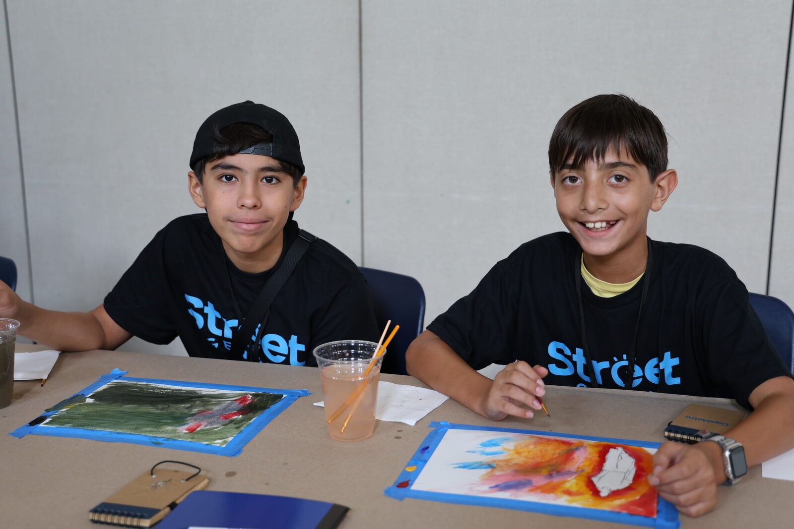 Young men painting in creative program